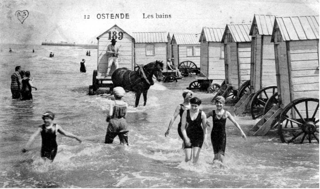 Mensen zoeken verfrissing in het water, Oostende, 1911. (© Postkaart van IBA, publiek domein)